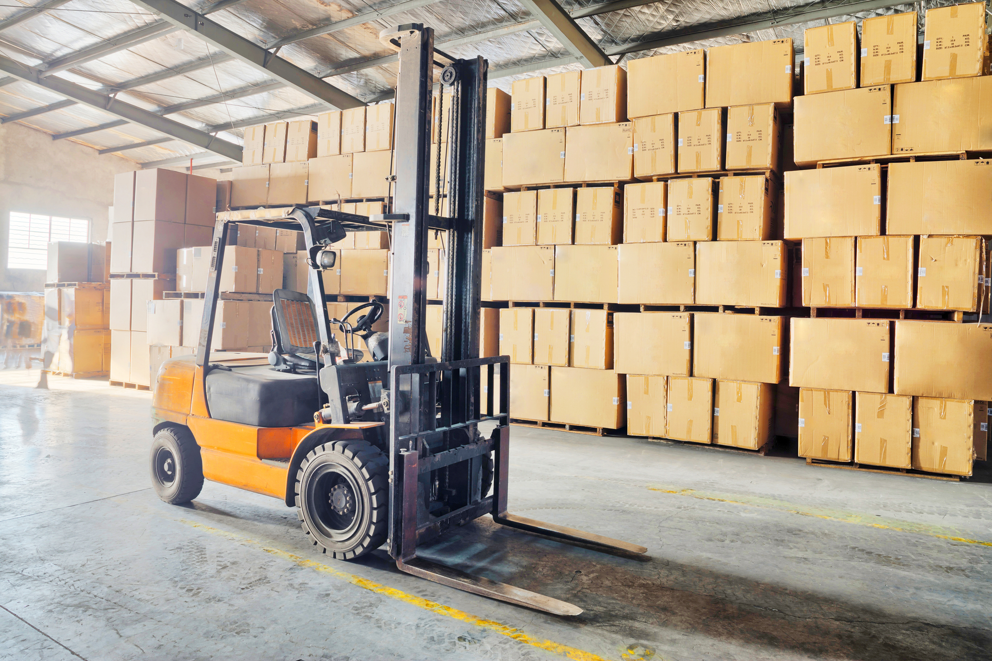 Large modern warehouse with forklifts